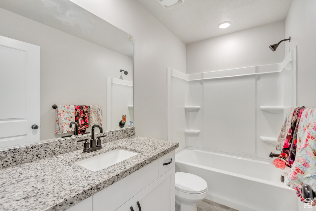 Full bathroom with tile patterned floors, vanity,  shower combination, and toilet