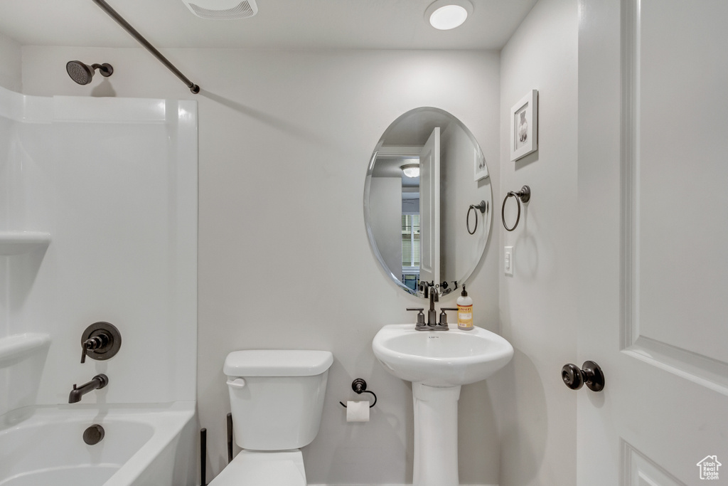 Bathroom with shower / tub combination and toilet