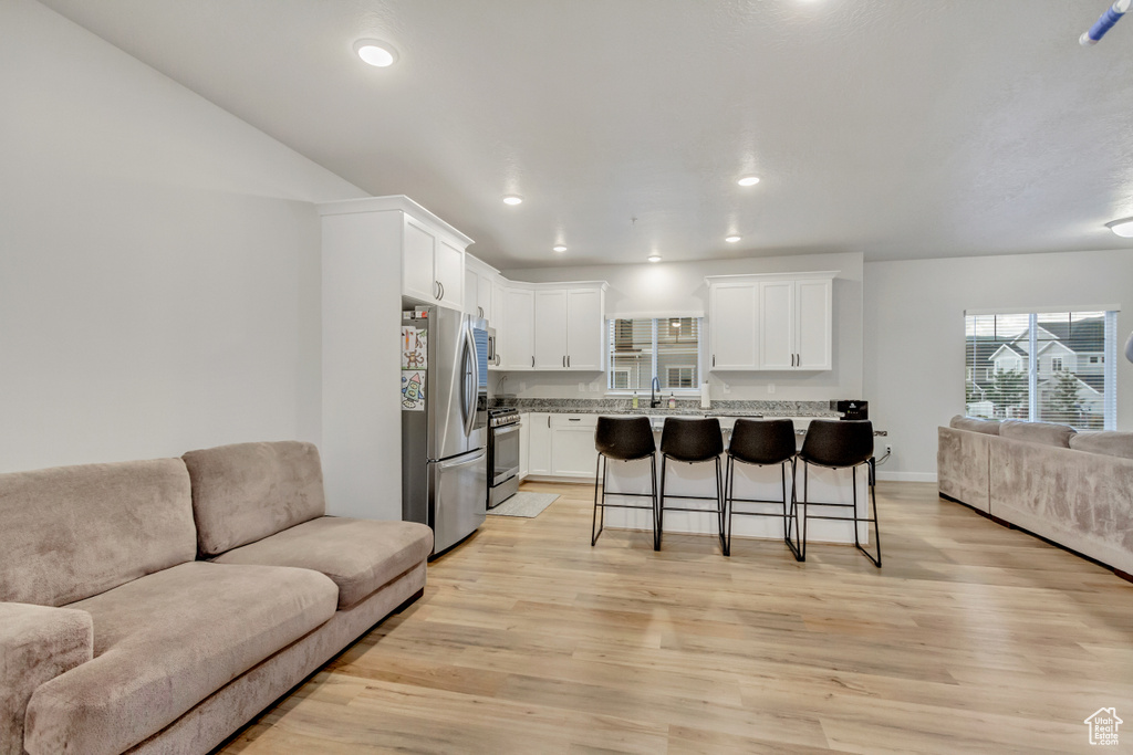 Living room with light hardwood / wood-style flooring