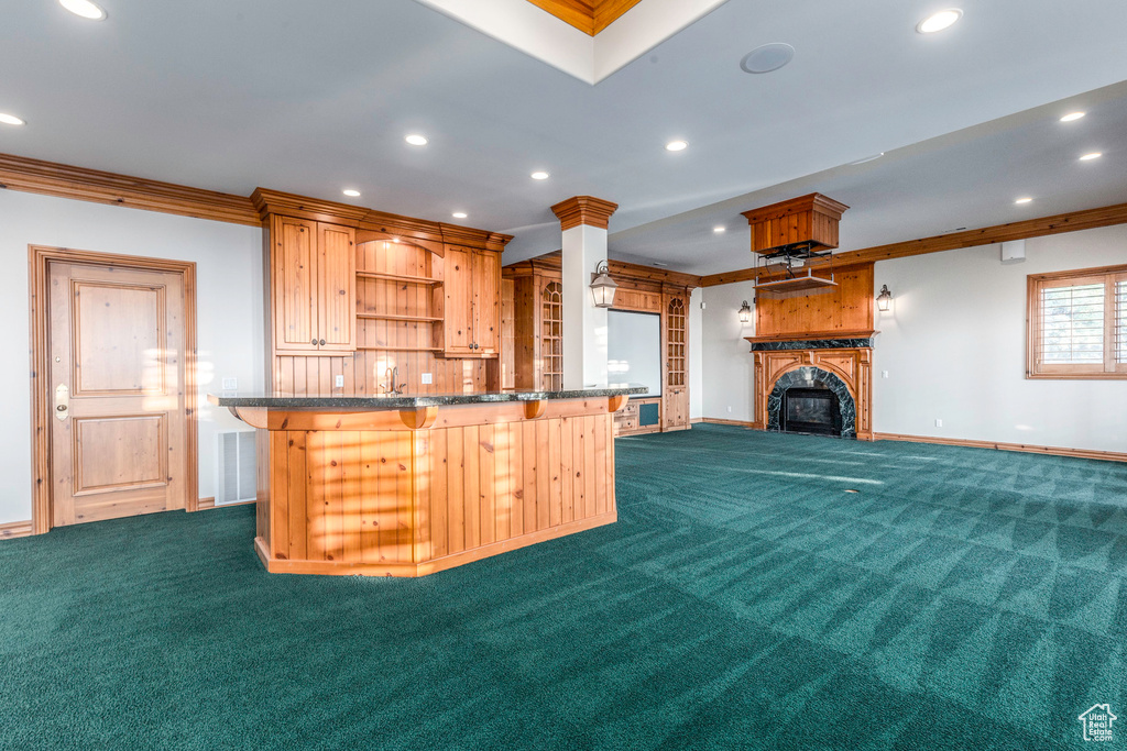 Kitchen with dark carpet and ornamental molding