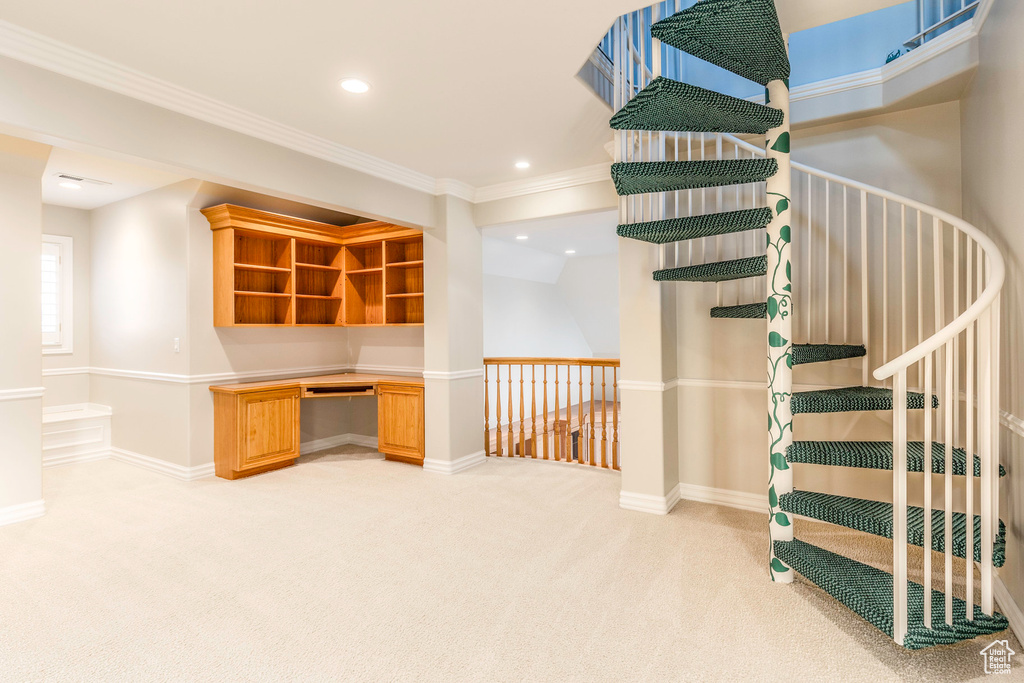 Interior space featuring ornamental molding and light carpet