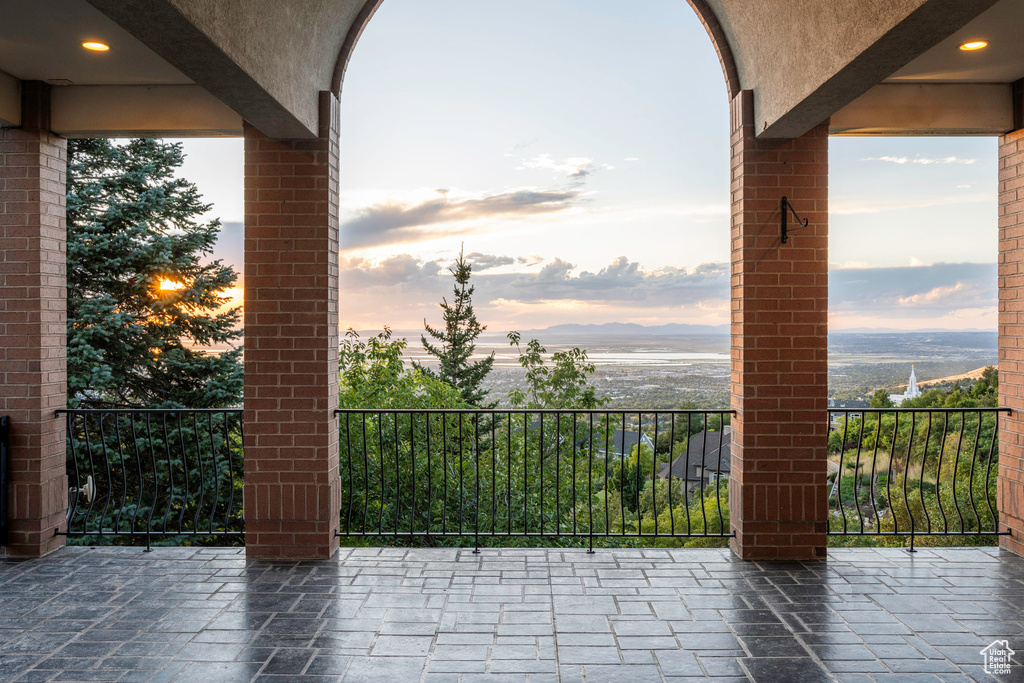 Patio terrace at dusk featuring a balcony