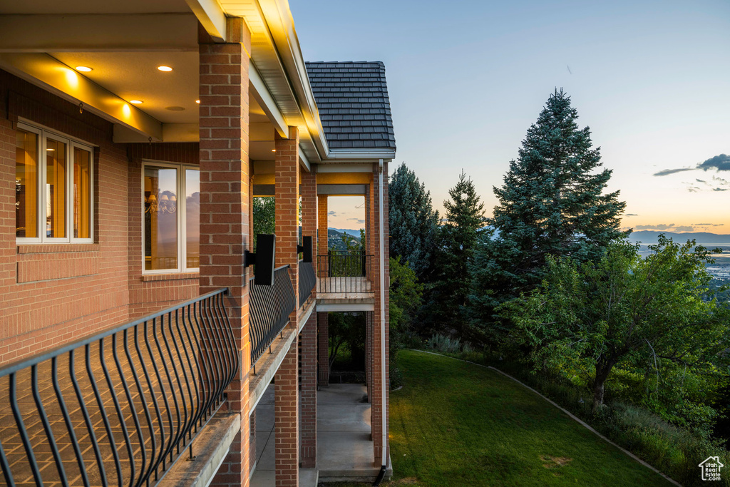 Property exterior at dusk with a yard