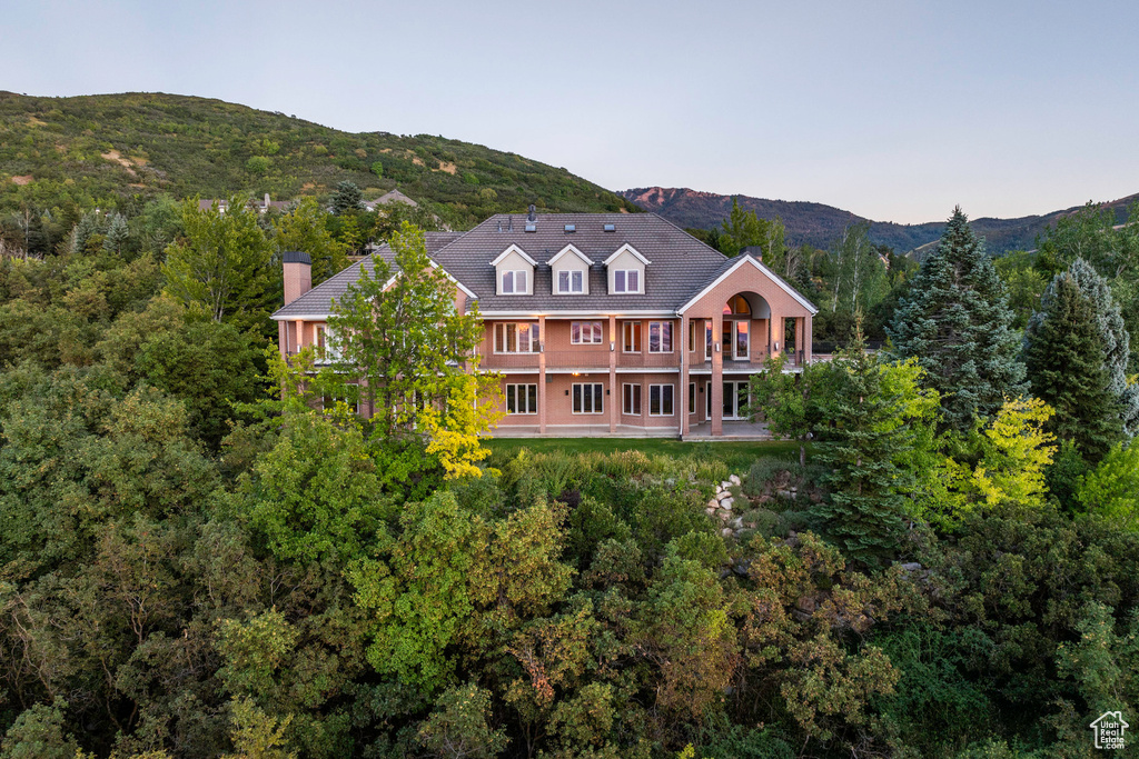 Back of property with a mountain view