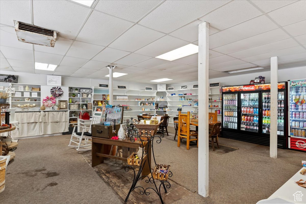 Miscellaneous room with a drop ceiling and carpet floors