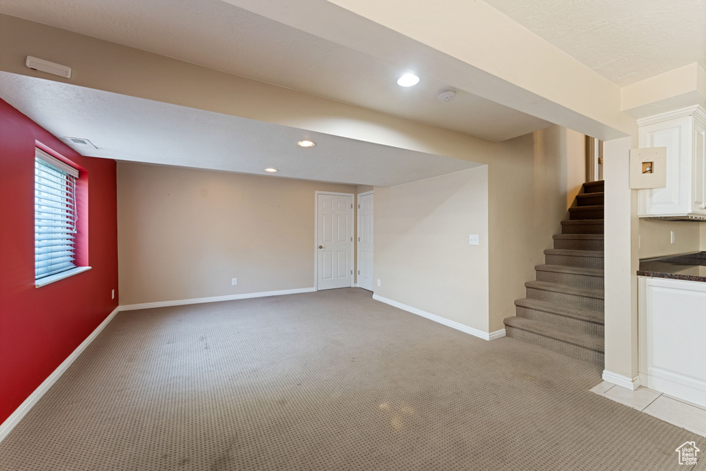 Basement with light colored carpet