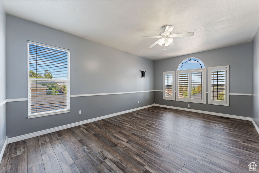 Empty room with wood-type flooring and ceiling fan