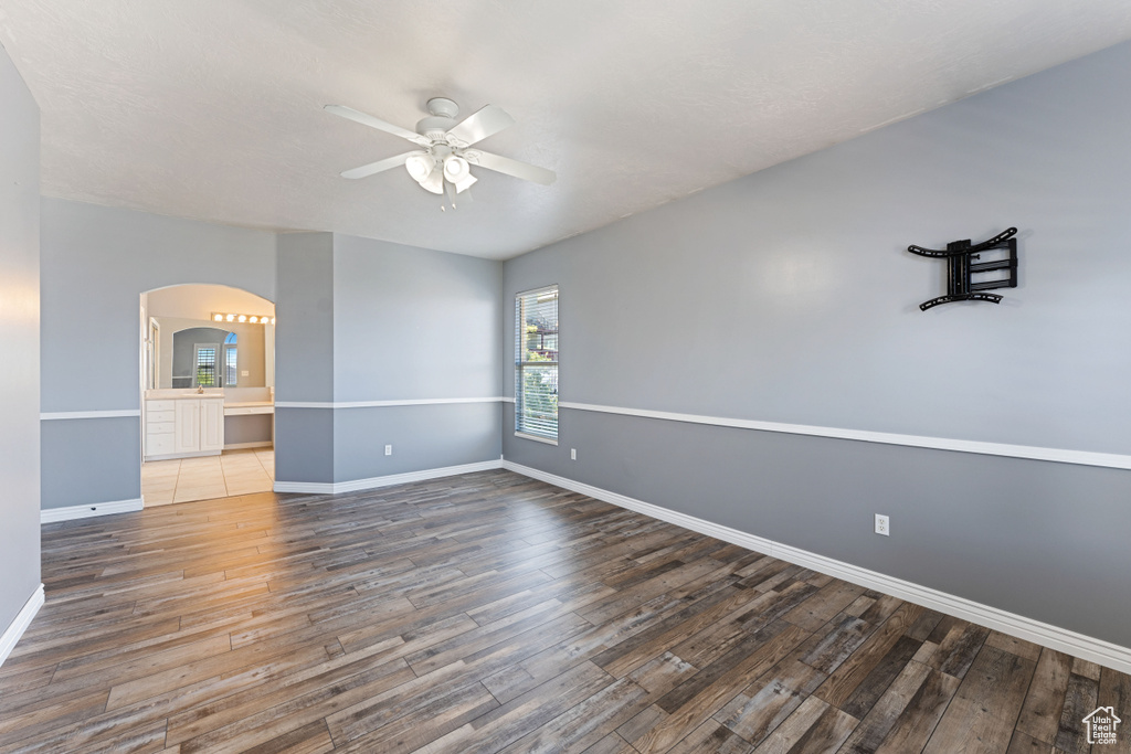 Empty room featuring tile patterned flooring and ceiling fan