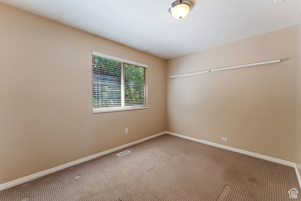 Empty room featuring carpet flooring