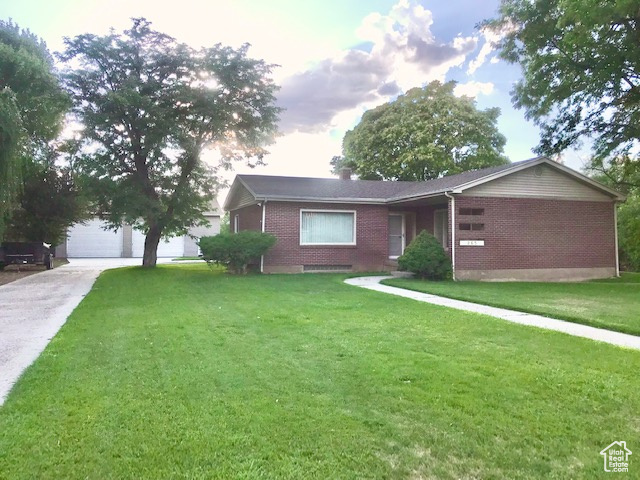 Ranch-style home with a garage and a front yard