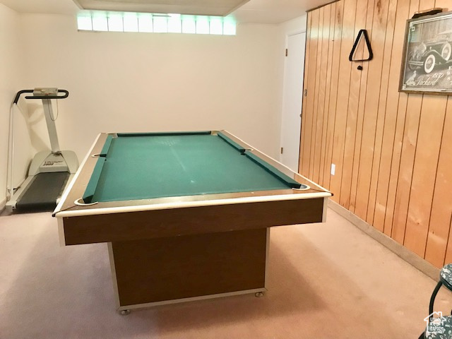 Rec room with wood walls and billiards