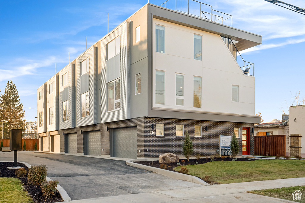 View of front of house featuring a garage and a front yard