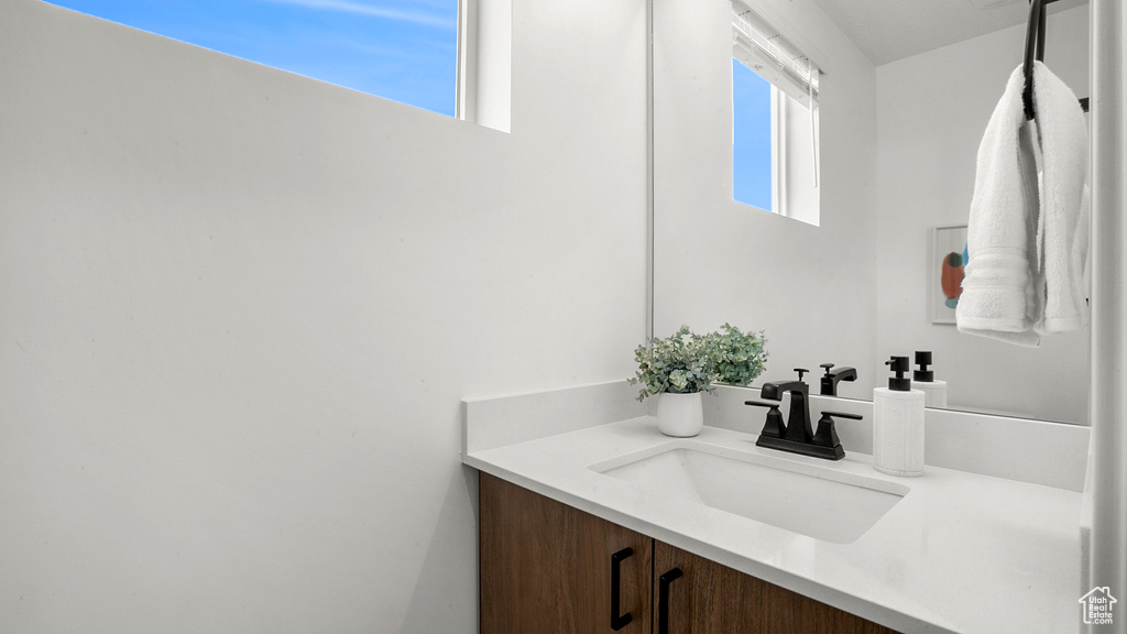 Bathroom with vanity and a wealth of natural light