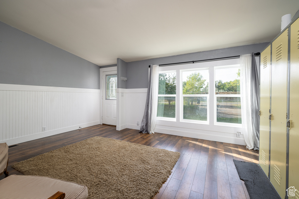Unfurnished living room featuring dark hardwood / wood-style floors