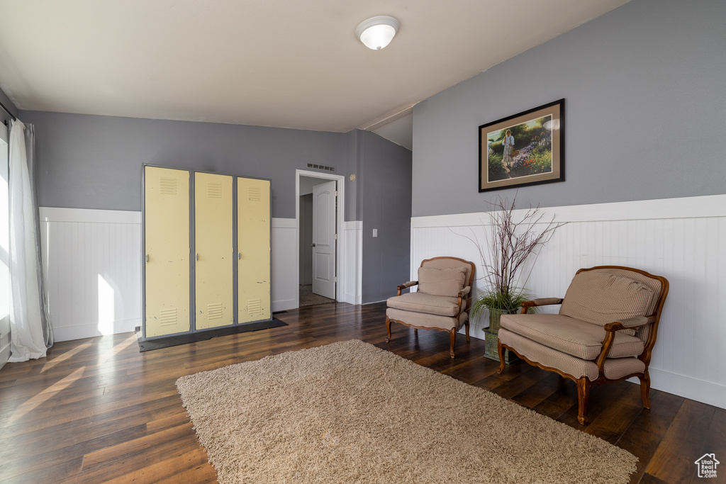 Living area with lofted ceiling and dark hardwood / wood-style floors