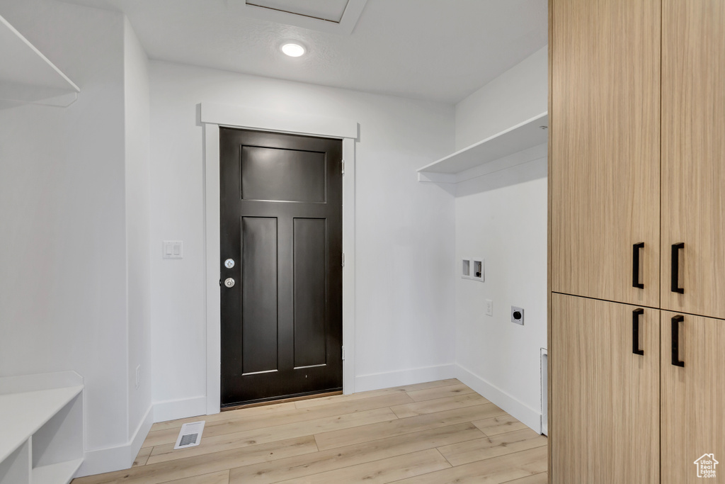 Laundry room featuring light hardwood / wood-style flooring, electric dryer hookup, and washer hookup