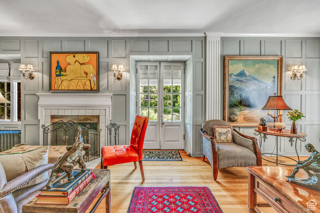 Interior space with a fireplace, french doors, and light wood-type flooring