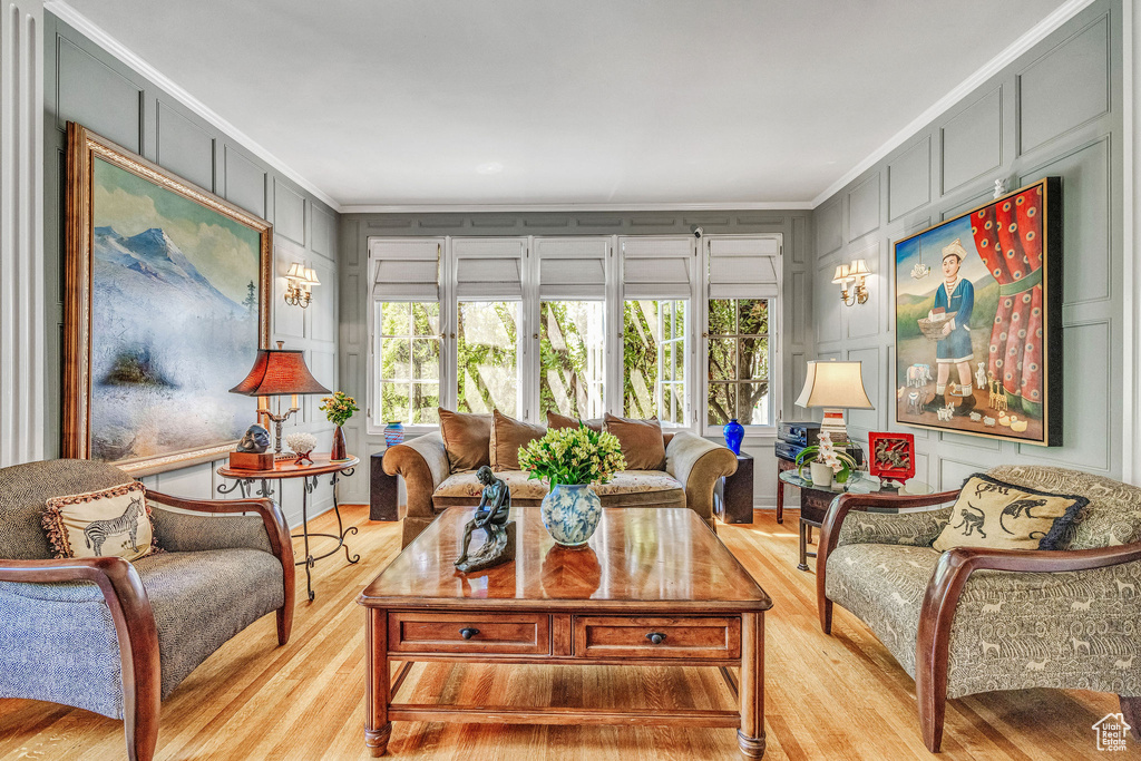 Living room featuring light hardwood / wood-style floors and crown molding