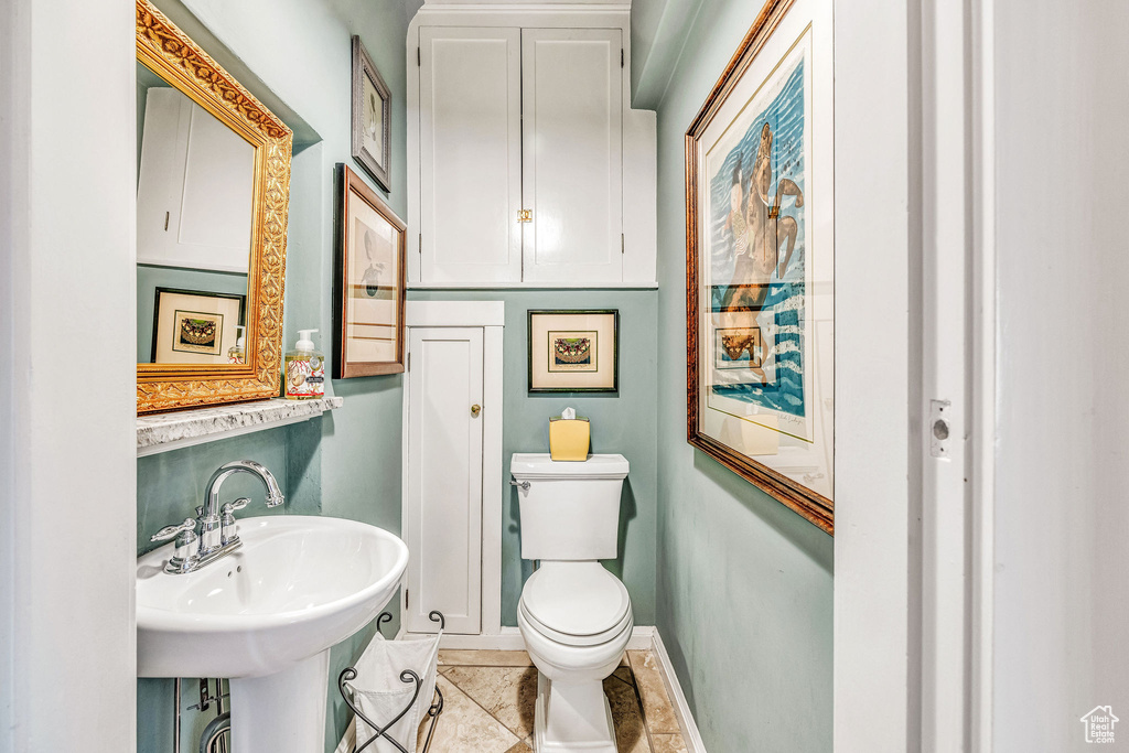 Bathroom with sink, toilet, and tile patterned flooring