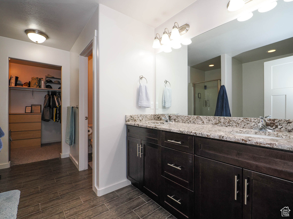 Bathroom with double vanity and an enclosed shower