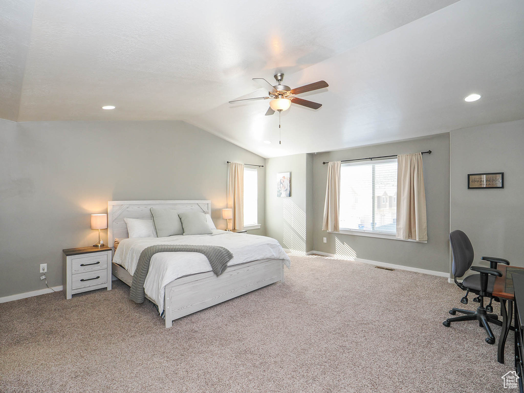 Bedroom featuring light carpet, vaulted ceiling, and ceiling fan