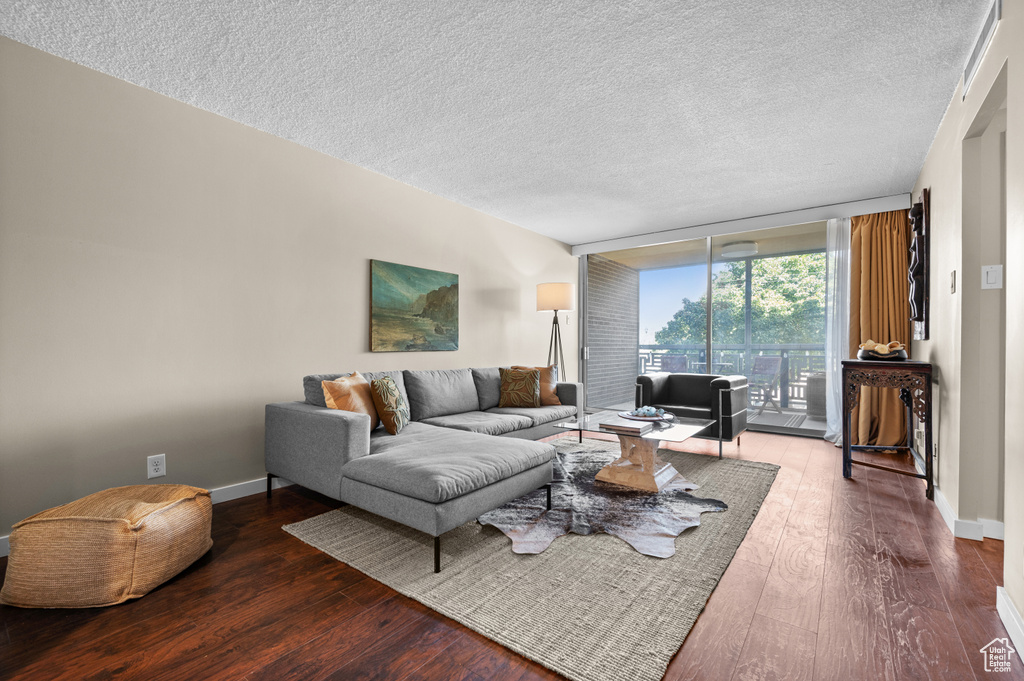 Living room featuring hardwood / wood-style floors and a textured ceiling