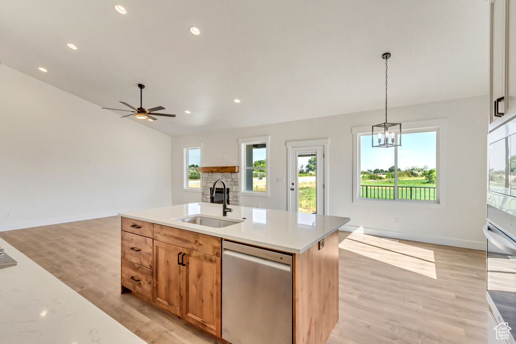 Kitchen featuring a center island with sink, light hardwood / wood-style flooring, appliances with stainless steel finishes, and sink