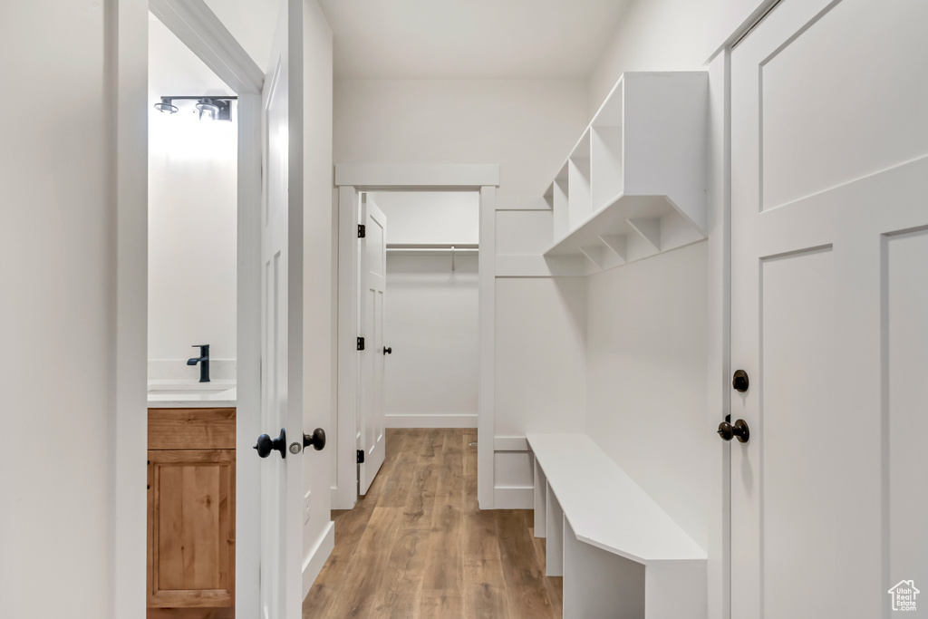 Mudroom with light hardwood / wood-style floors and sink