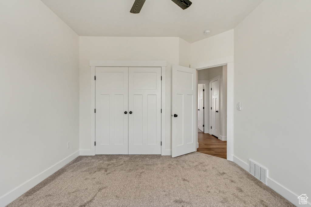 Unfurnished bedroom featuring light hardwood / wood-style floors, a closet, and ceiling fan