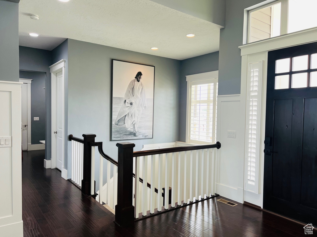 Entrance foyer with hardwood / wood-style floors