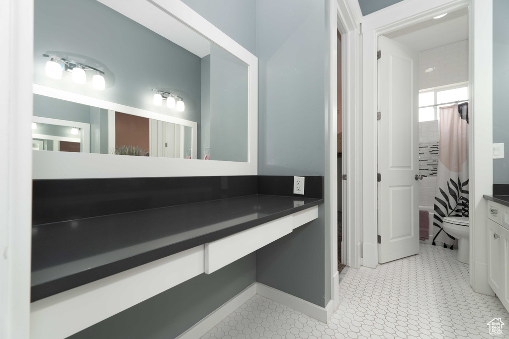 Full bathroom with shower / tub combo, tile patterned floors, toilet, and vanity