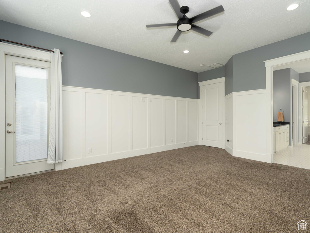 Spare room with light carpet and ceiling fan