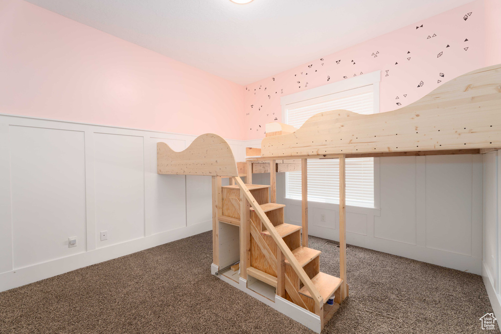 Unfurnished bedroom with a closet and carpet floors