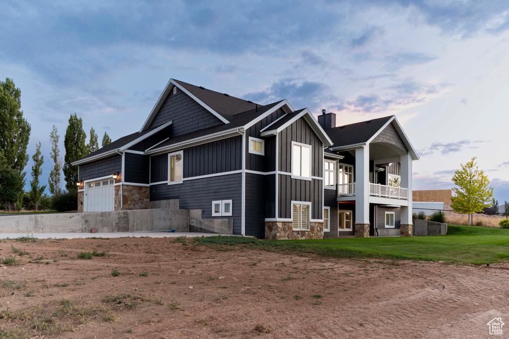 Exterior space with a balcony and a yard