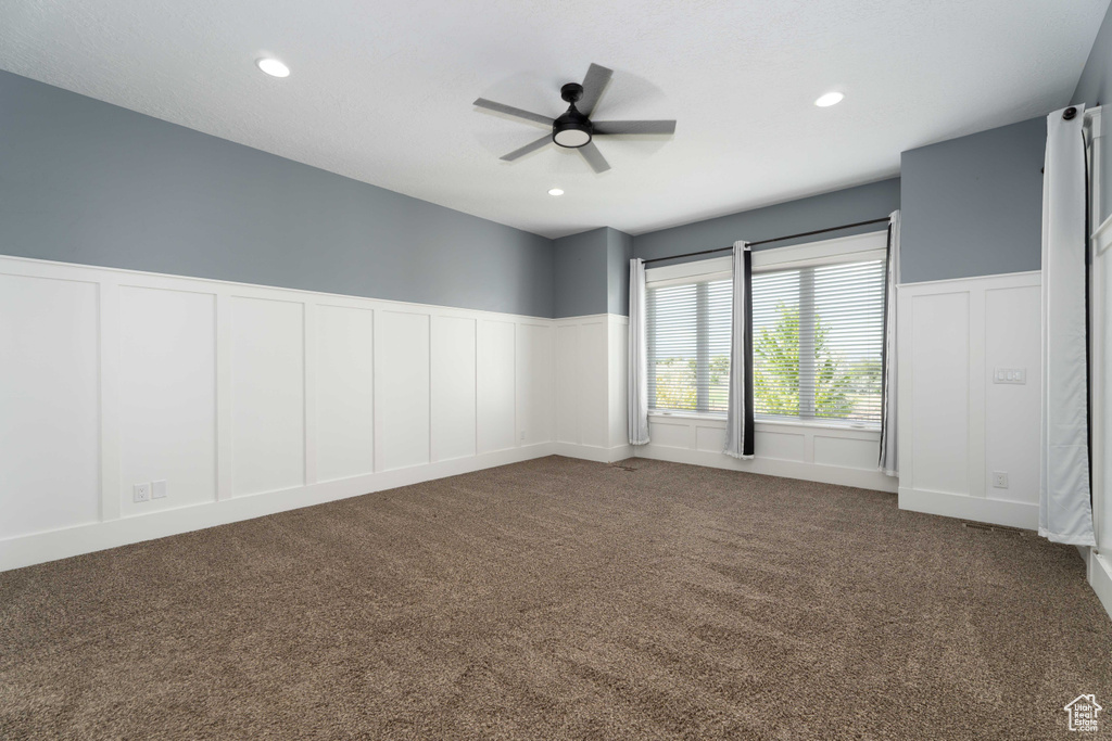 Spare room with carpet and ceiling fan