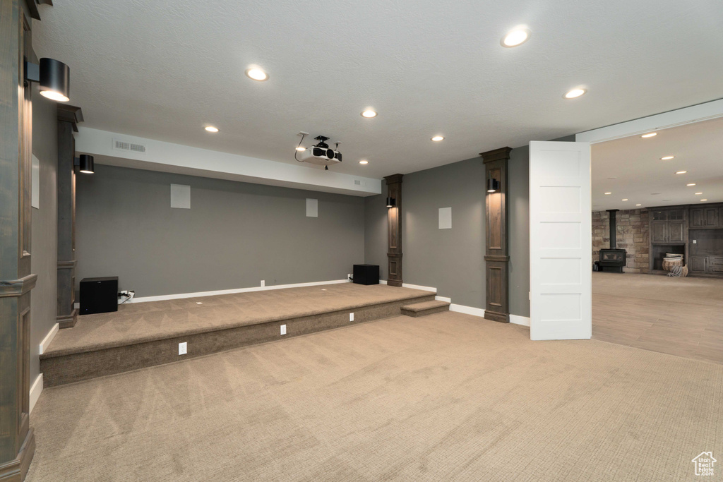 Carpeted cinema with a wood stove