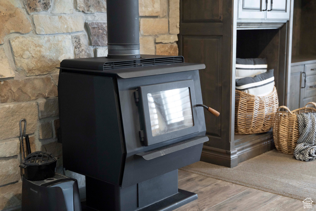 Details with a wood stove and hardwood / wood-style floors