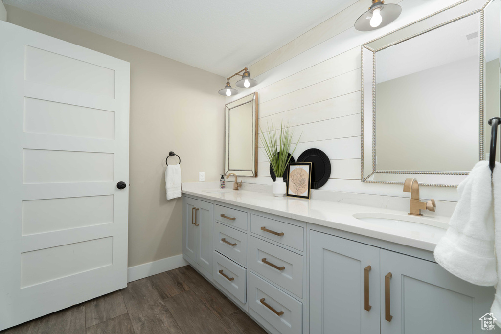 Bathroom featuring hardwood / wood-style flooring and double sink vanity
