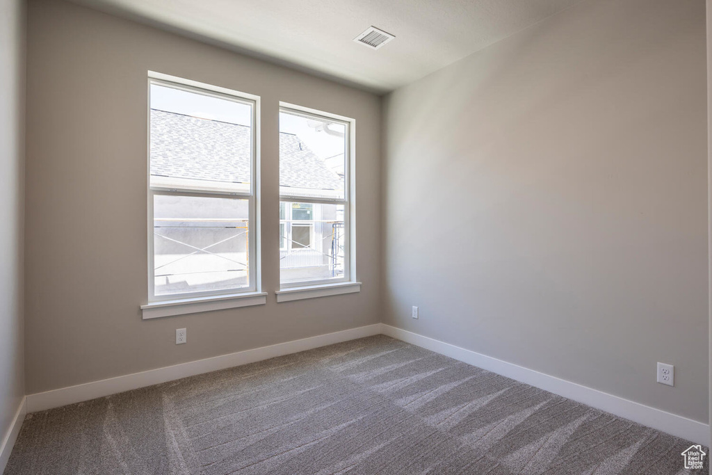 Empty room with carpet floors