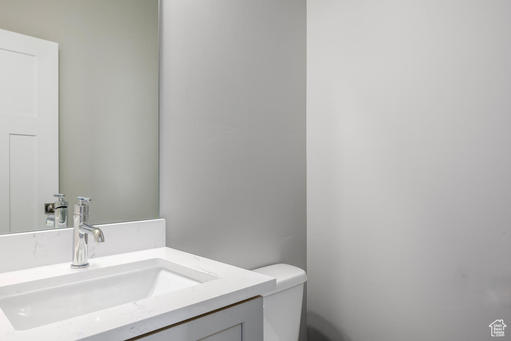 Bathroom featuring vanity and toilet