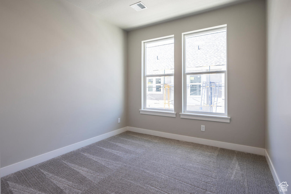 Unfurnished room with carpet