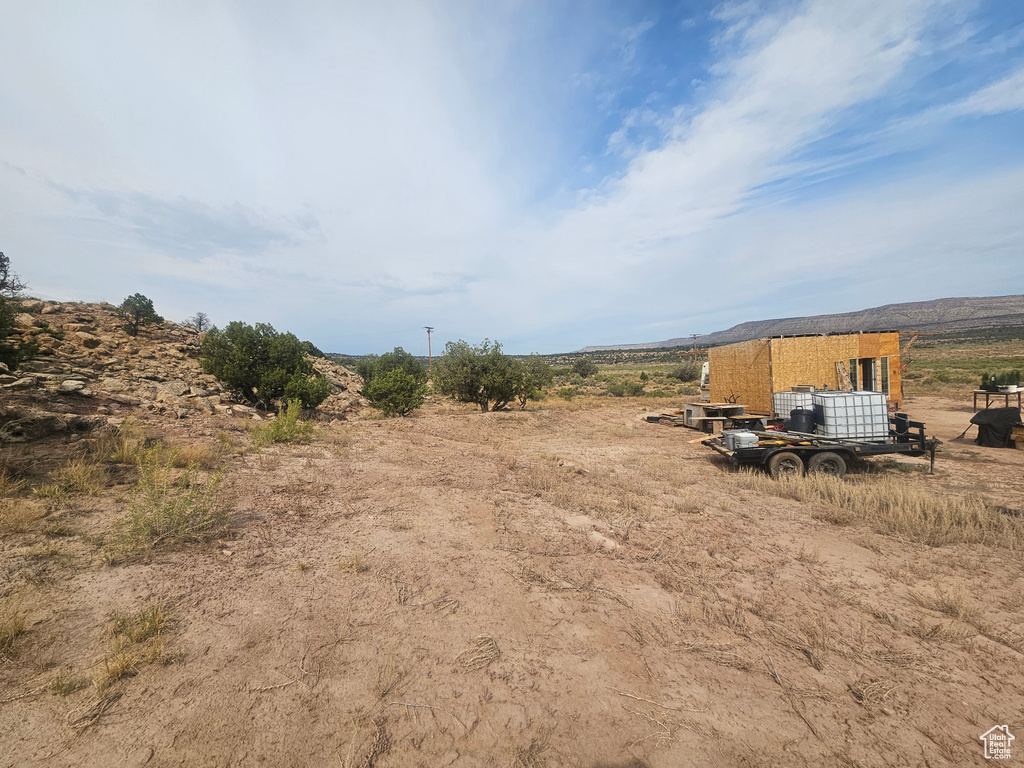 View of yard with an outdoor structure and a rural view