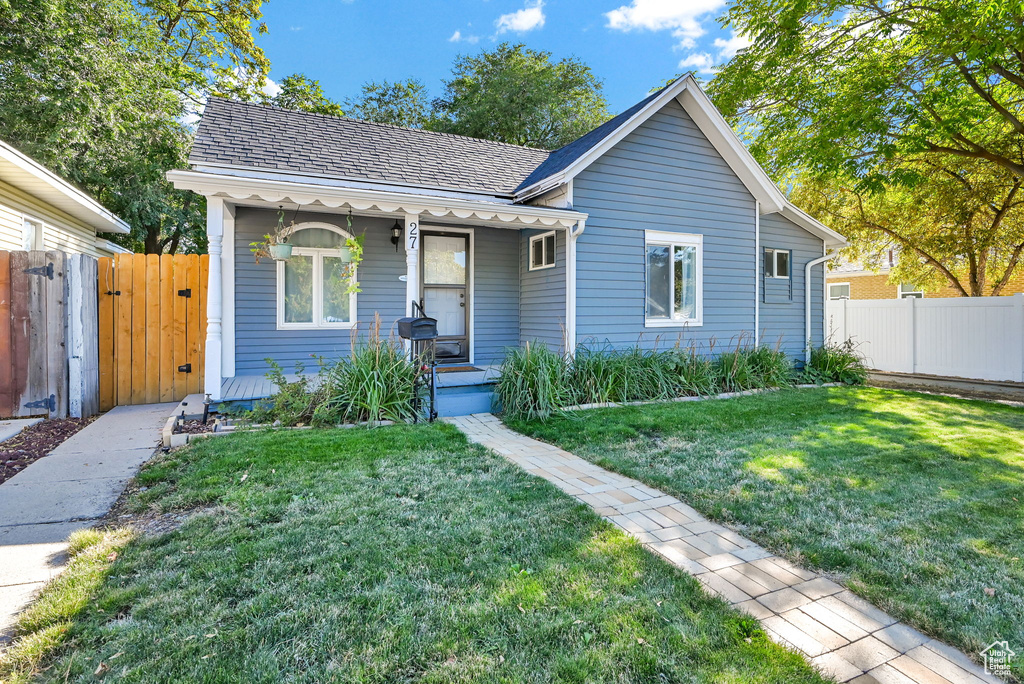 Single story home featuring a front lawn