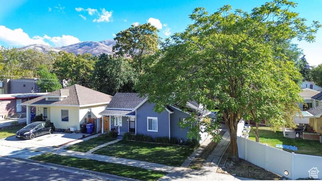 Exterior space featuring a front yard and a mountain view