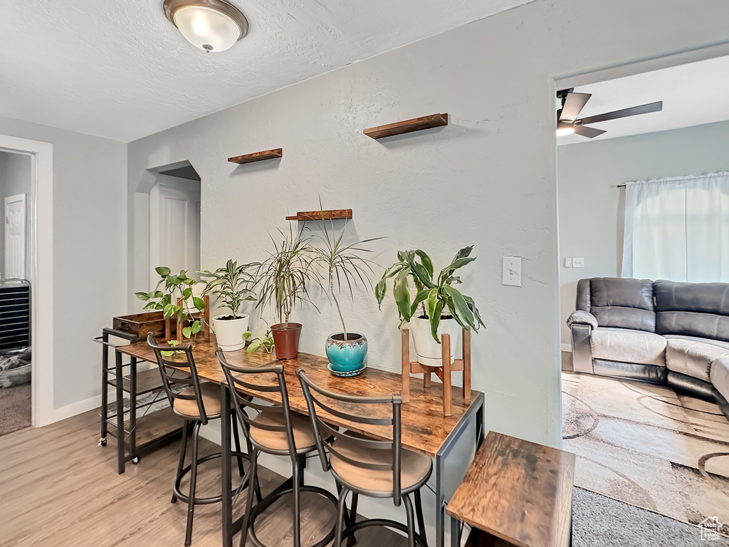 Dining area with wood-type flooring and ceiling fan