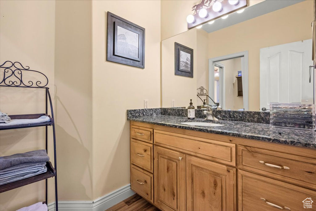 Bathroom with vanity and wood-type flooring