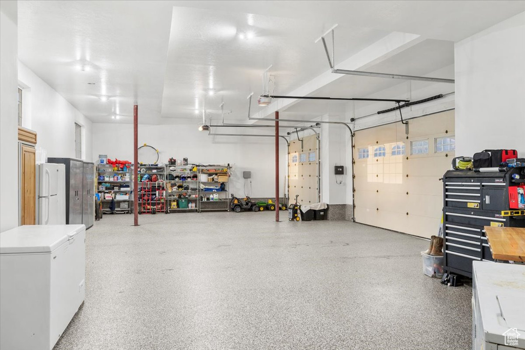 Garage featuring white refrigerator