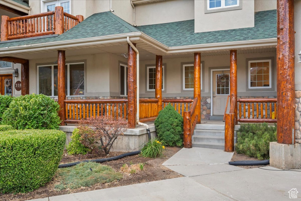 Entrance to property featuring covered porch