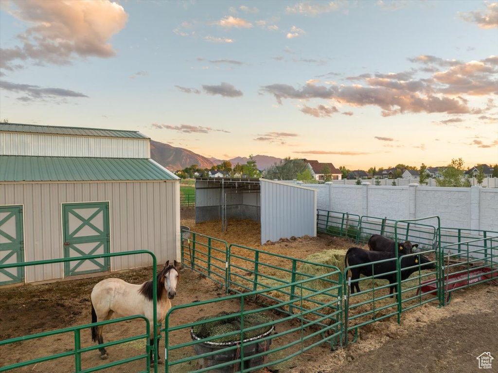 View of horse barn with a storage unit