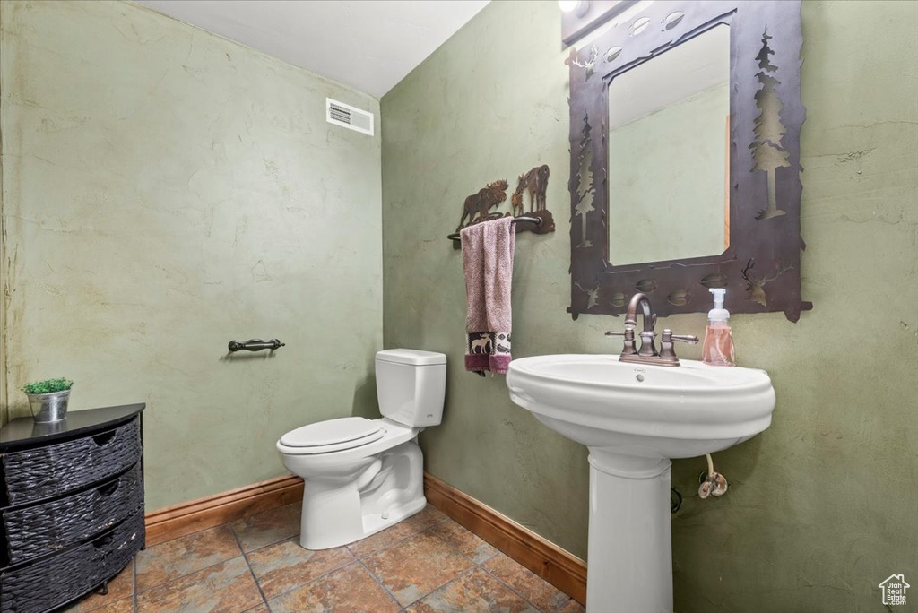 Bathroom featuring tile patterned flooring and toilet